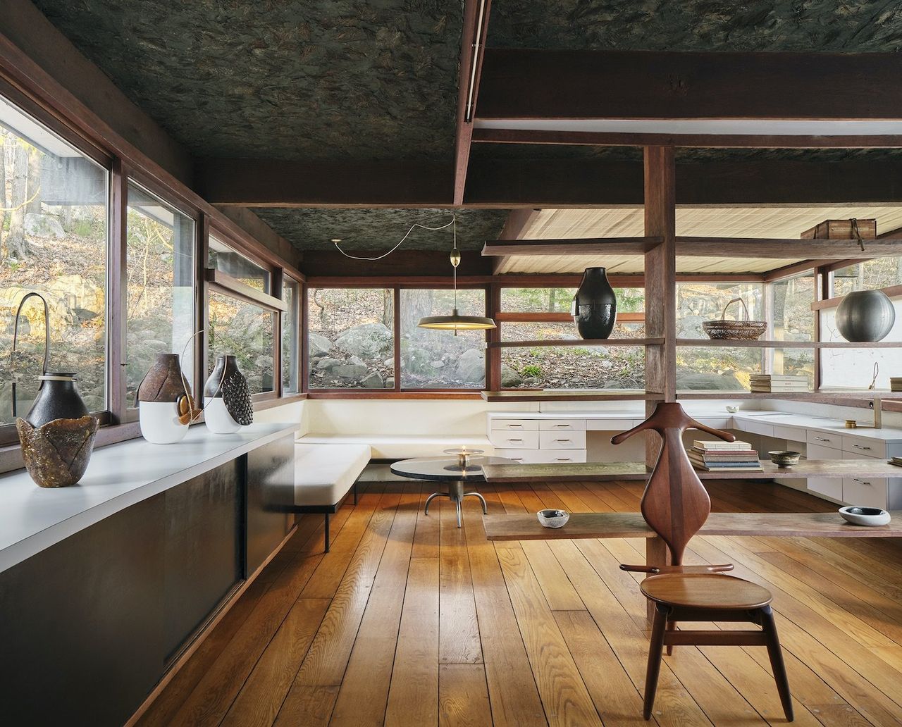 A modernist house hosts a series of wooden and ceramic sculptures.