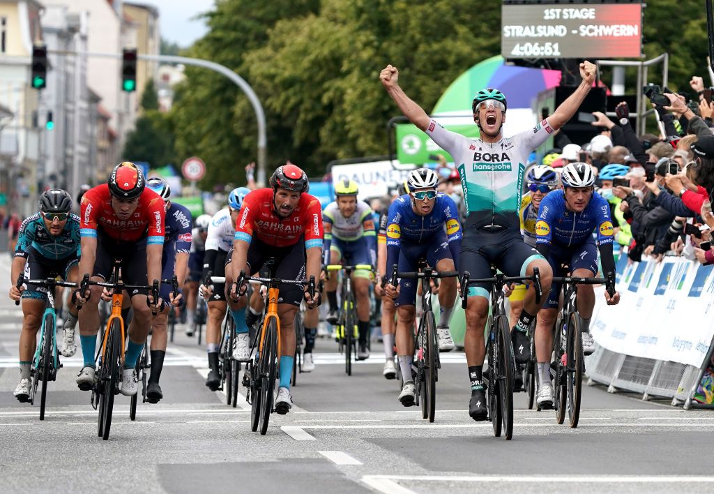 SCHWERIN GERMANY AUGUST 26 Pascal Ackermann of Germany and Team Bora Hansgrohe celebrates at finish line as stage winner ahead of Phil Bauhaus of Germany Marco Haller of Austria and Team Bahrain Victorious L and Yves Lampaert of Belgium and Team Deceuninck QuickStep R during the 35th Deutschland Tour 2021 Stage 1 a 191km stage from Stralsund to Schwerin DeineTour on August 26 2021 in Schwerin Germany Photo by Christian KasparBartkeGetty Images