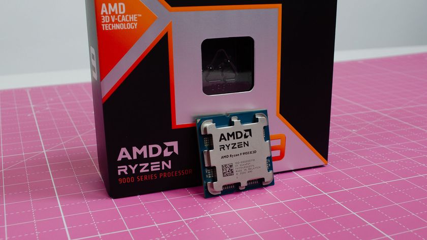 AMD Ryzen 9950X3D chip next to its packaging on a pink table