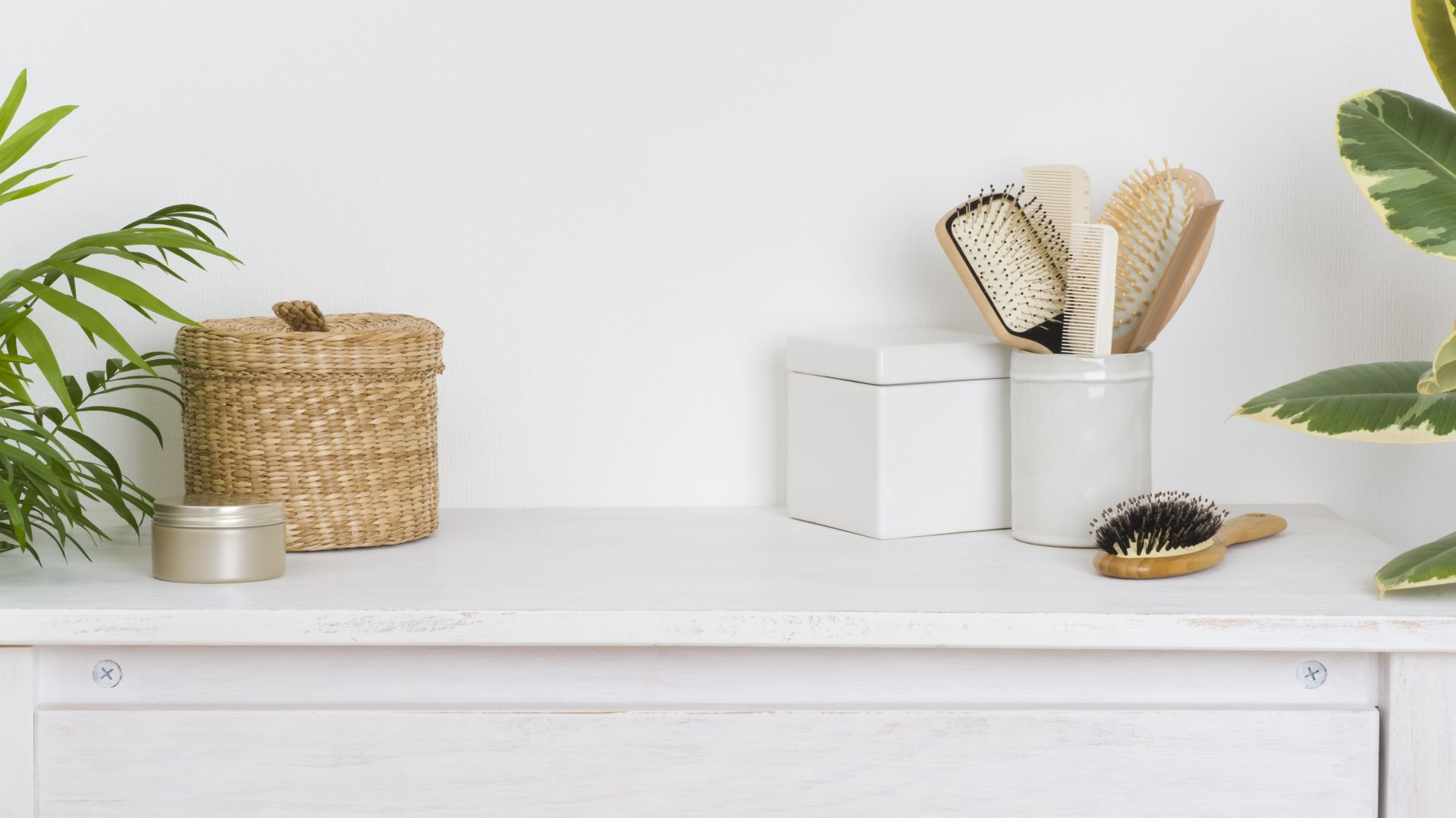white shelf with wicker storage basket and jar with hairbrushes