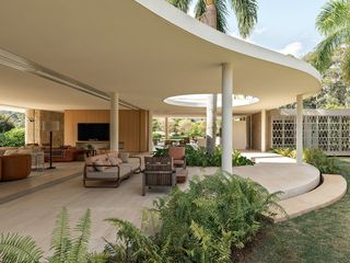 casa das palmeiras with its minimalist, low, white forms, curved openings and indoor/outdoor relationships in sao paulo's warm climate lifestyle