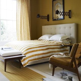 mustard bedroom scheme with striped duvet