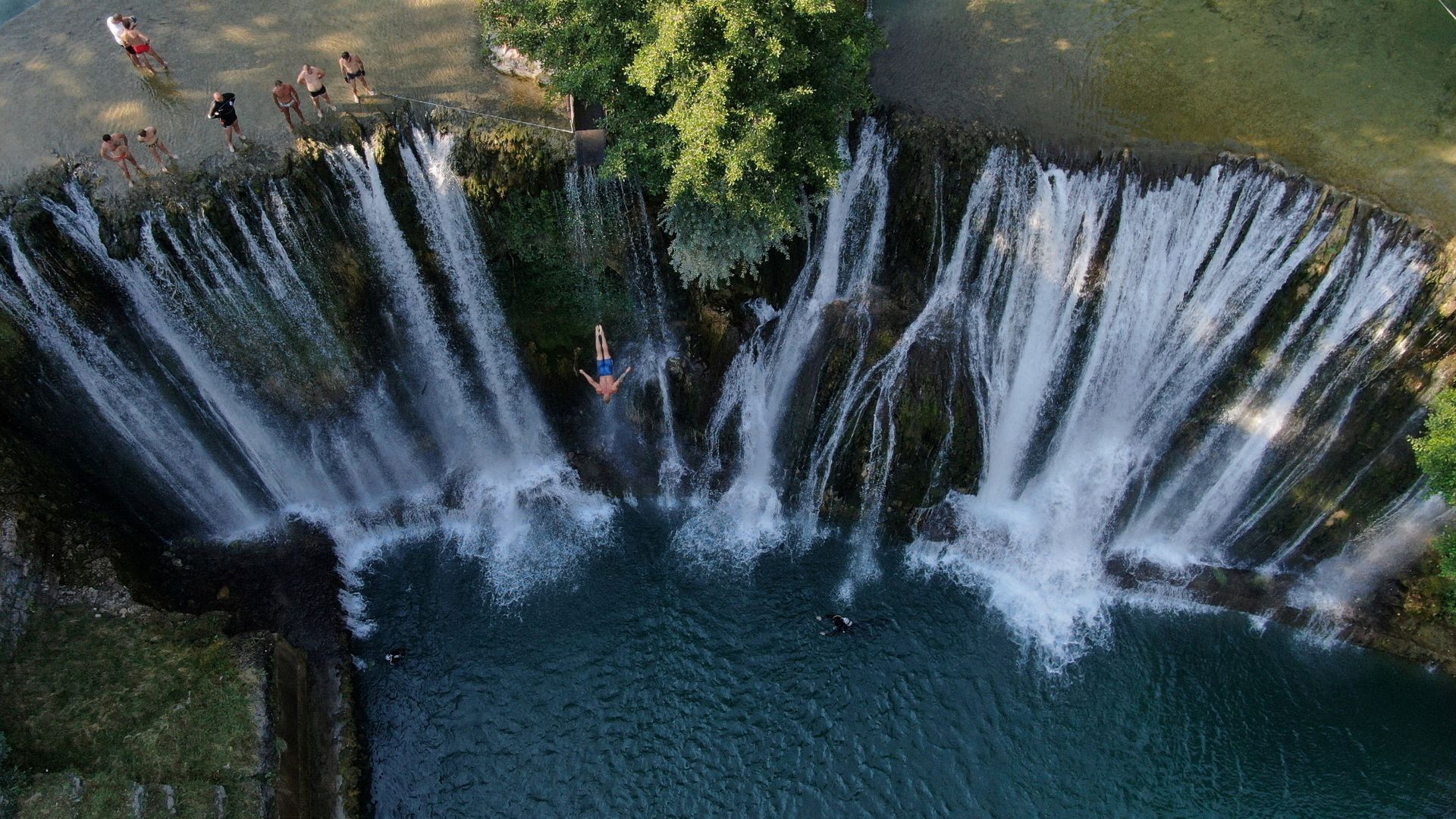 
                                People compete in the annual international waterfall jumping competition in Jajce, Bosnia and Herzegovina
                            