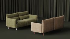 two sofas face each other in a dark green curtained room