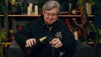 A screencap of a video by Path of Exile 2 developer Grinding Gear Games featuring game director Jonathan Rogers pouring champagne into a glass.