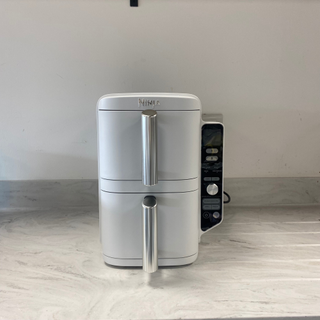 The Ninja Double Stack Air Fryer in white on a marble countertop.