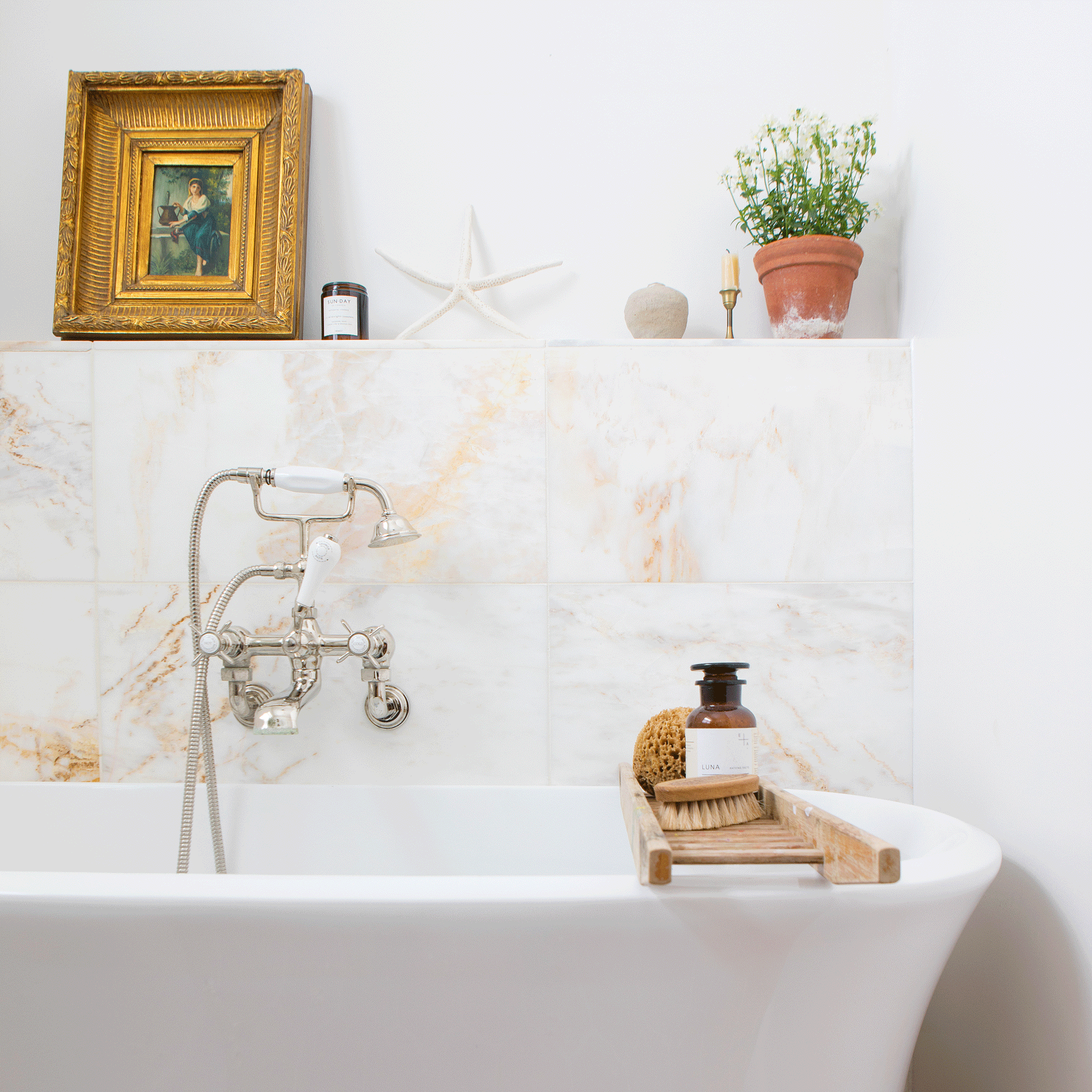 a neutral bathroom with a large contemporary bath tub and a classic artwork