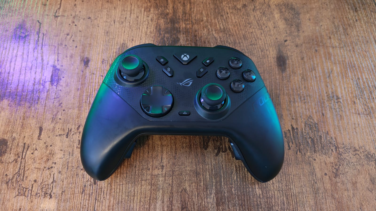 An Asus ROG Raikiri 2 controller lying on a gaming desktop