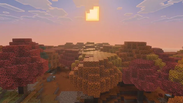 Wide view of the Dappled Forest biome at sunset, displaying dense clusters of red, orange, yellow, and pink-toned trees.