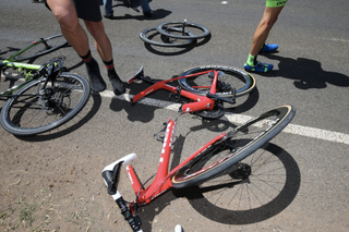 The best bicycle insurance will cover your bike even if it's beyond repair. This image shows a red bike on the road that has been snapped in two.