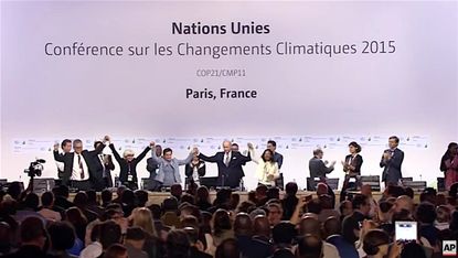 Delegates from 195 nations agree to a landmark climate accord