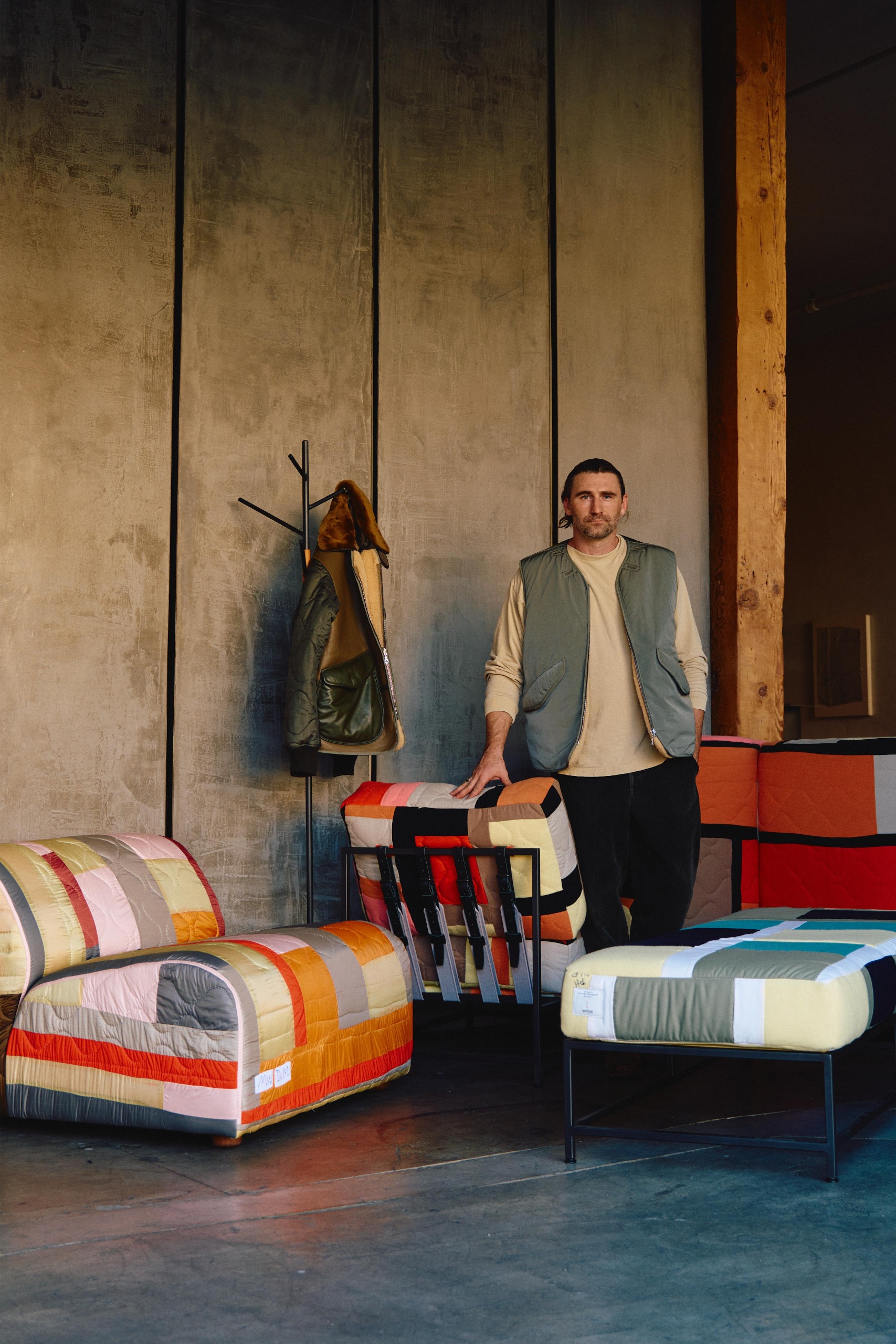 Portrait of furniture designer Stephen Kenn with quilted chairs