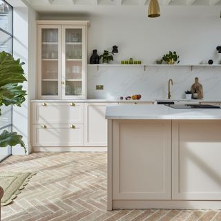 Pale pink shaker kitchen with terracotta tiles
