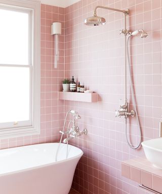 Small bathroom tiled with pink wall and floor tiles