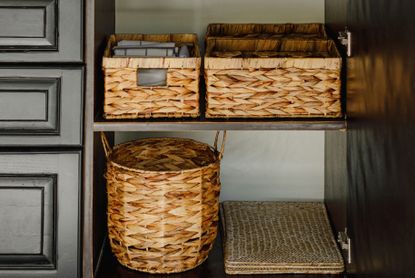 Black shelves with sea grass storage containers