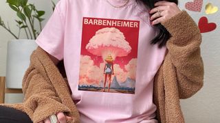 Barbenheimer t-shirt being modelled on a woman wearing a cardigan