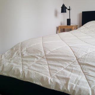 The Woolroom Deluxe Washable Wool Duvet being tested on a bed