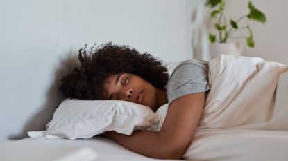 Woman getting into core sleep at night with head on the pillow