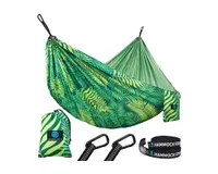 A multicolor green leaf print hammock with tree straps