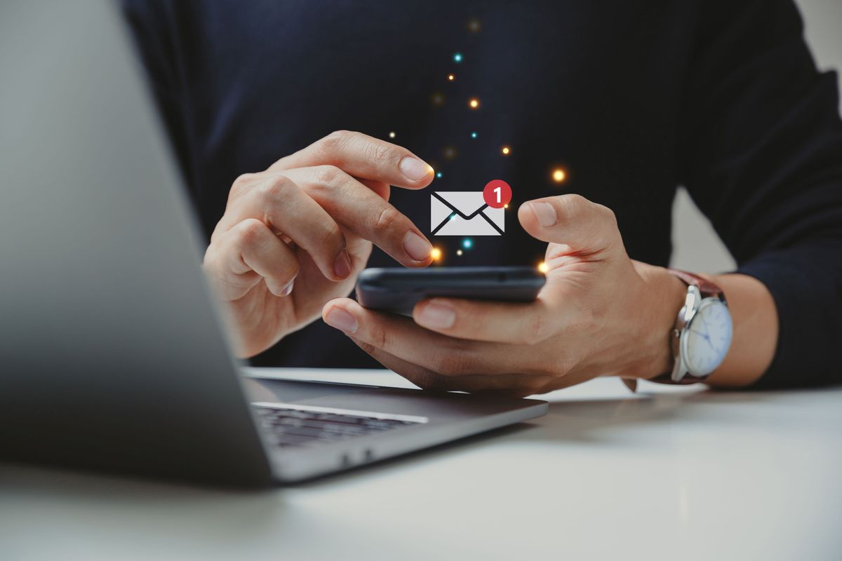 Man receiving email notification on his phone