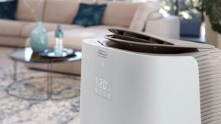 Pinguino GentleJet Inverter in the foreground. it's in a neutrally decorated living room