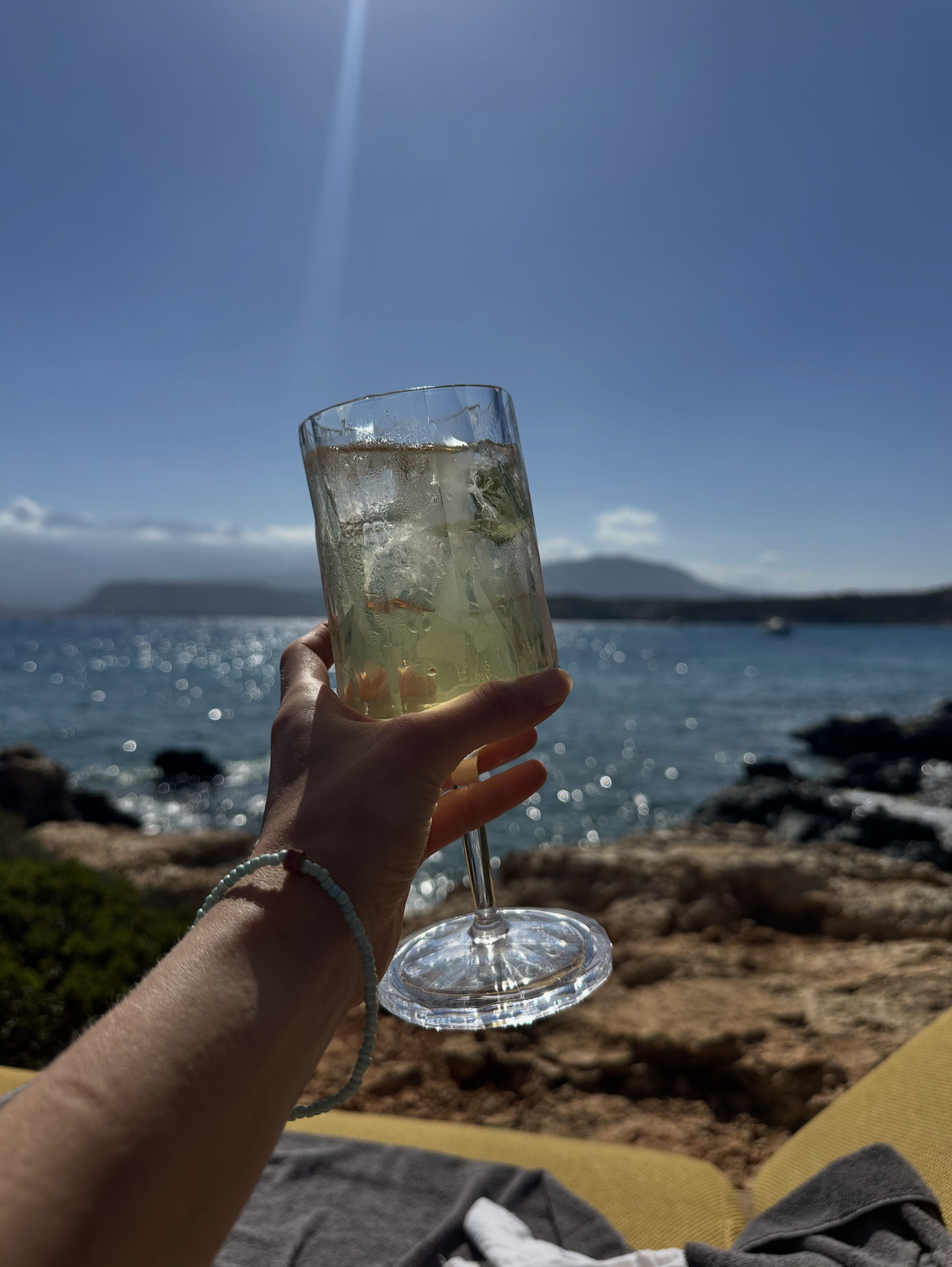 a hand holding up a cocktail in Crete, Greece