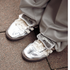 COPENHAGEN, DENMARK - AUGUST 8: A guest wears a grey suit with pearls, a silver Bottega bag, and silver Adidas sneakers outside Kernemilk during the Copenhagen Fashion Week Spring/Summer 2024 on August 8, 2023 in Copenhagen, Denmark. (Photo by Raimonda Kulikauskiene/Getty Images)