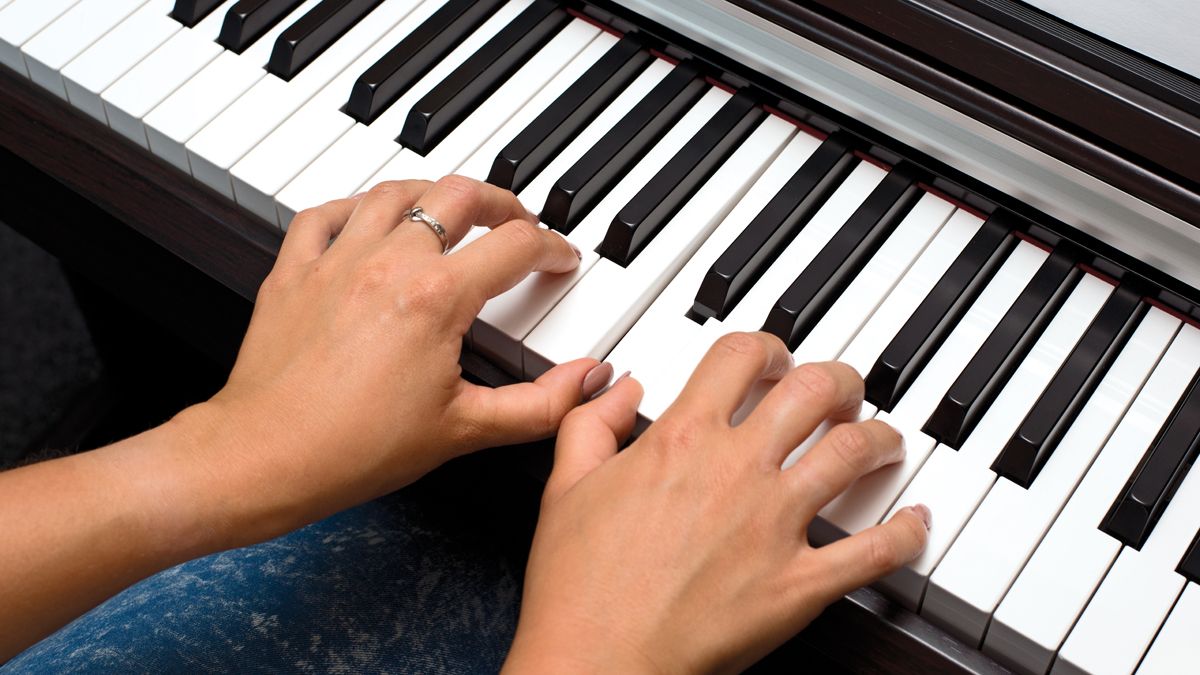 Hands on piano keyboard