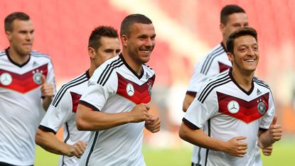 Arsenal's Lukas Podolski and Mesut Ozil train with Germany