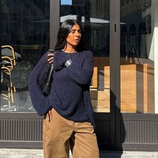 @monikh wearing navy jumper