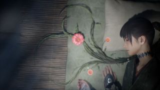 A woman lies next to some flowers