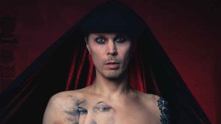Ville Valo with a cloak over his head