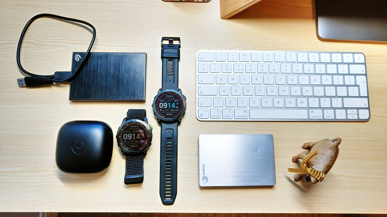 Garmin Enduro 2 and Fenix 7X on a computer desk