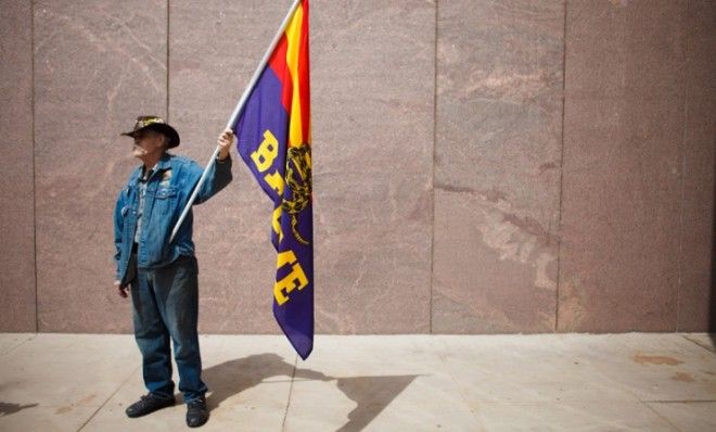 A Tea Partier stands alone before a rally in Arizona on April 25.