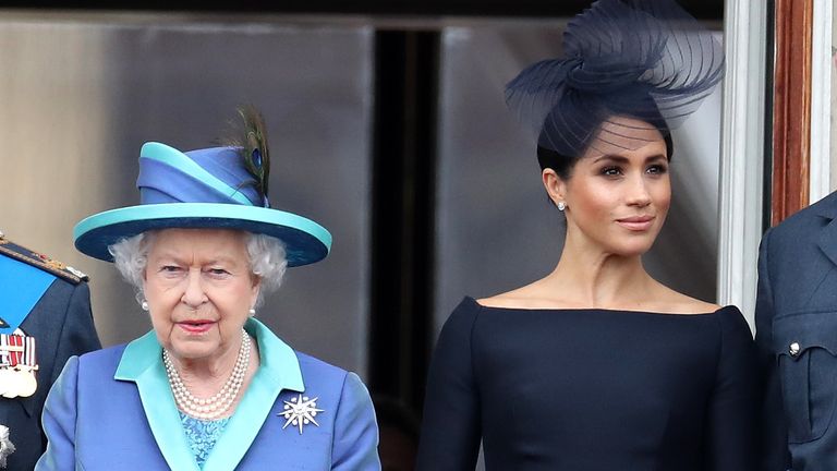 Queen Elizabeth II and Meghan, Duchess of Sussex on the balcony of Buckingham Palace as the Royal family attend events to mark the Centenary of the RAF on July 10, 2018 in London, England