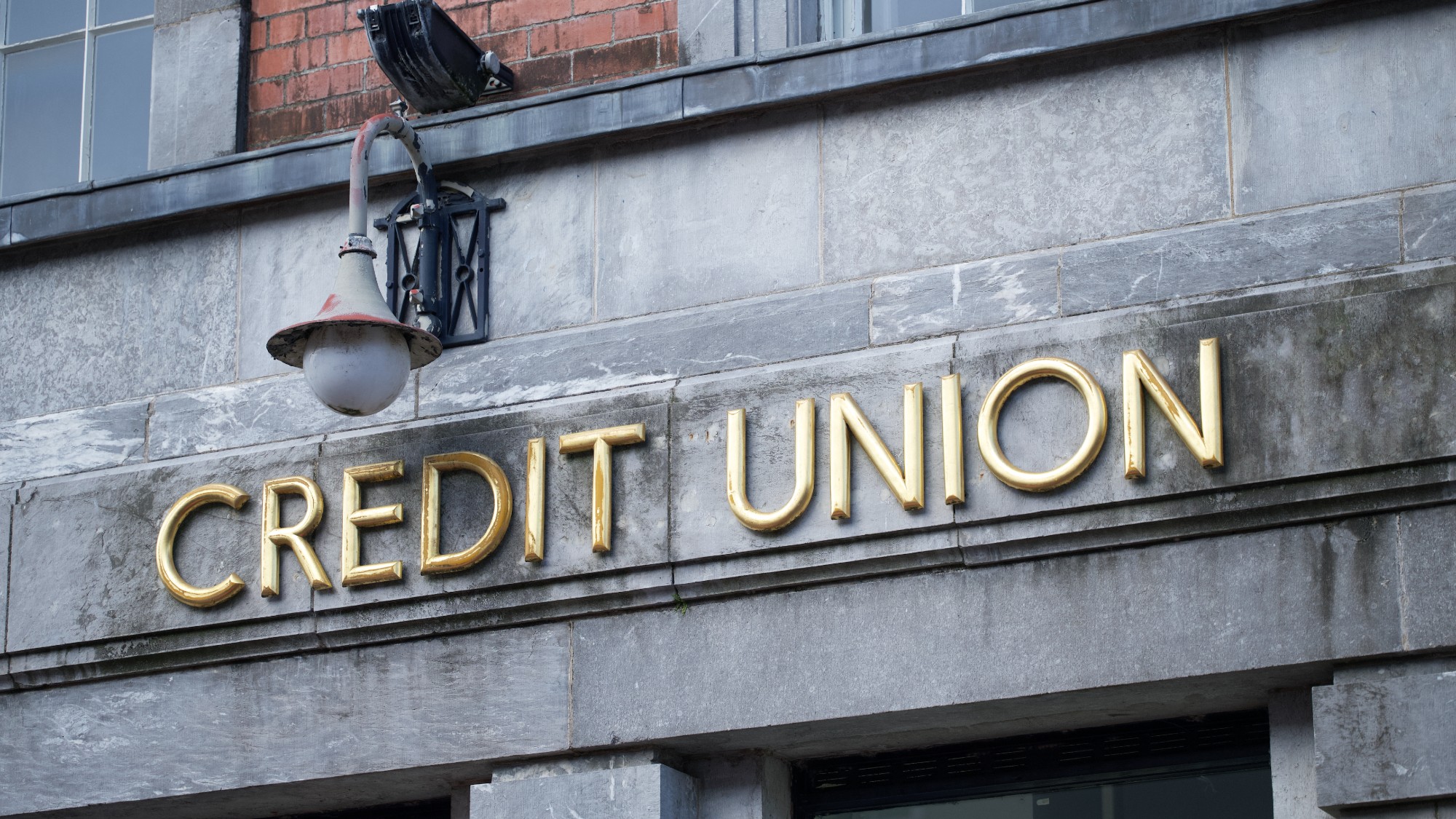 Credit union sign on stone wall