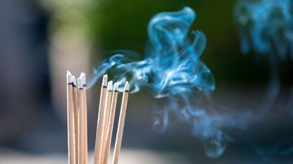 Incense sticks with smoke rising