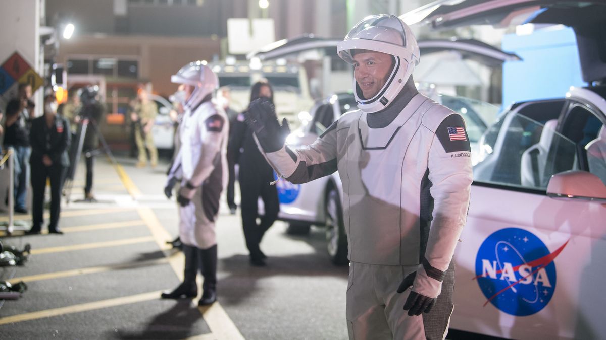 NASA astronaut Kjell Lindgren waves to family and friends as he and crew mates, NASA astronauts Robert Hines, Jessica Watkins, and ESA (European Space Agency) astronaut Samantha Cristoforetti, wearing SpaceX spacesuits, depart the Neil A. Armstrong Operations and Checkout Building for Launch Complex 39A to board the SpaceX Crew Dragon spacecraft for the Crew-4 mission launch, Tuesday, April 26, 2022, at NASA&rsquo;s Kennedy Space Center in Florida.