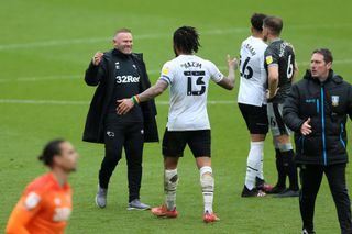 Derby manager Wayne Rooney (left) celebrates the club's Sky Bet Championship survival with Colin Kazim-Richards (13) after a final-day draw with Sheffield Wednesday