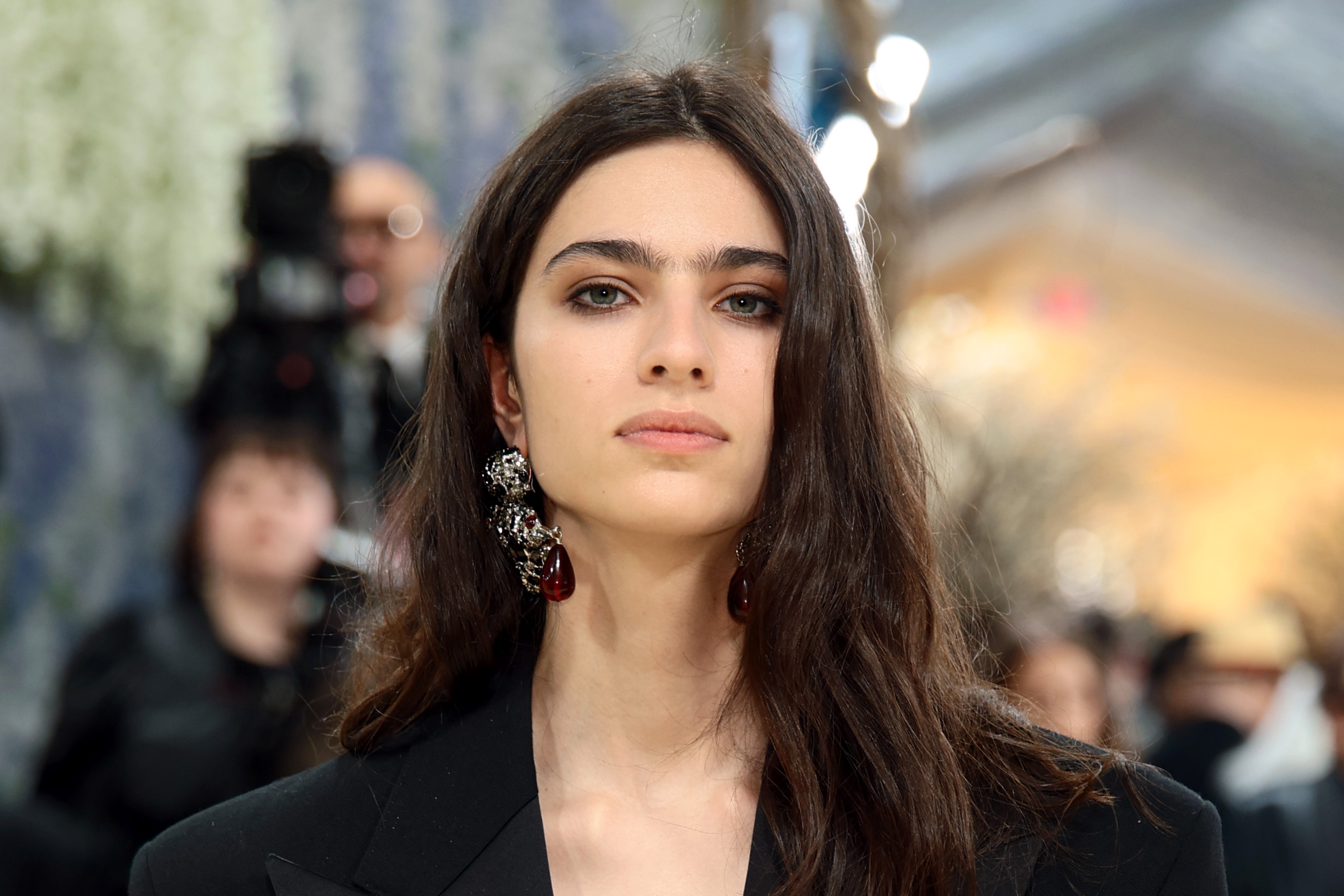 a woman with dark eyes and brunette hair in a black jacket