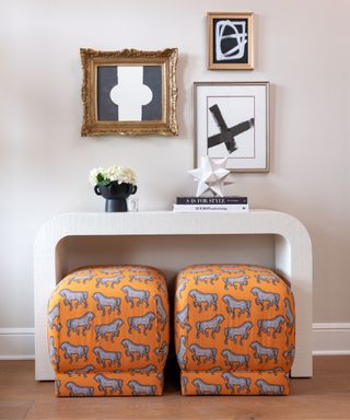 desk with orange seating and artwork