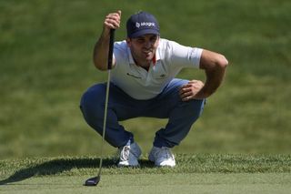 Denny McCarthy of the United States lines up a putt on the 11th green during the final round of the Memorial Tournament
