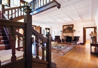 entrance hall with wooden flooring and curved staircase