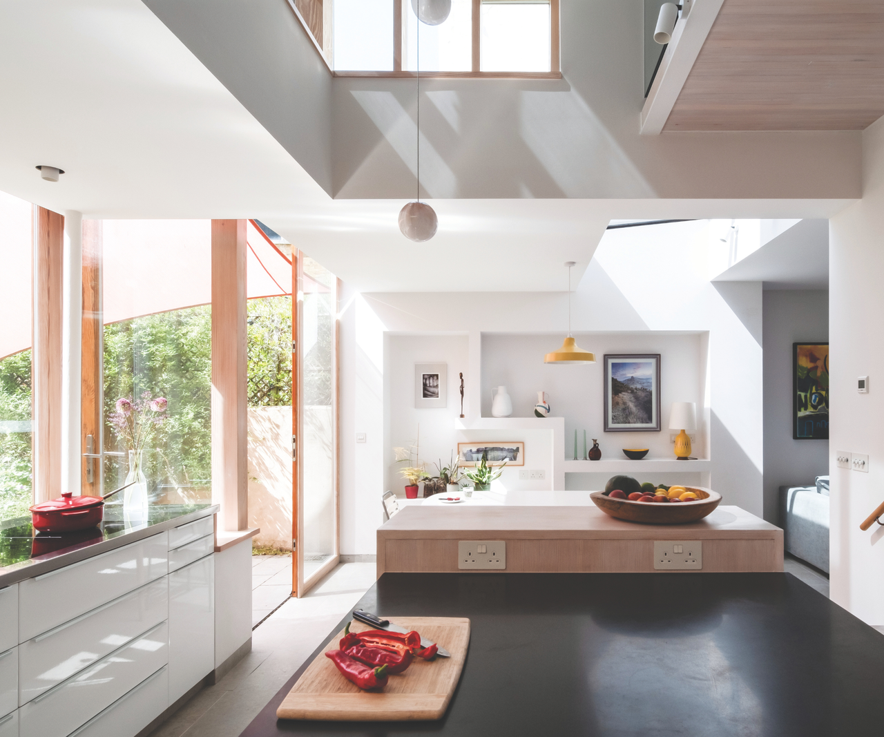 Open plan kitchen with windows to the garden on the left hand side
