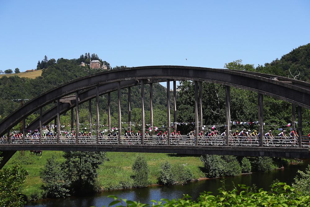 The Tour de France peloton crosses a bridge during stage 6