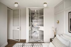 a small ensuite with a glass crittall door