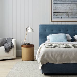 best colour combinations, blue and white coastal bedroom, tongue and groove white walls, blue bed, armchair, artwork