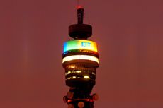 A close up photo of the BT tower lit up at night