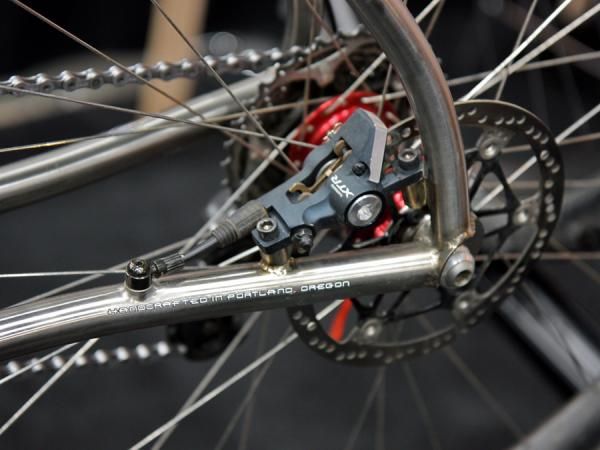 Vertigo Cycles principal Sean Chaney fed a titanium hydraulic tube all the way through the frame, starting at the front of the down tube and finishing back on the chain stay.