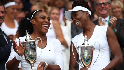 Venus Williams of The United States and Serena Williams of The United States hold their trophies following victory in the Ladies Doubles Final against Timea Babos of Hungary and Yaroslava Shvedova of Kazakhstan on day twelve of the Wimbledon Lawn Tennis Championships at the All England Lawn Tennis and Croquet Club on July 9, 2016 in London, England. 